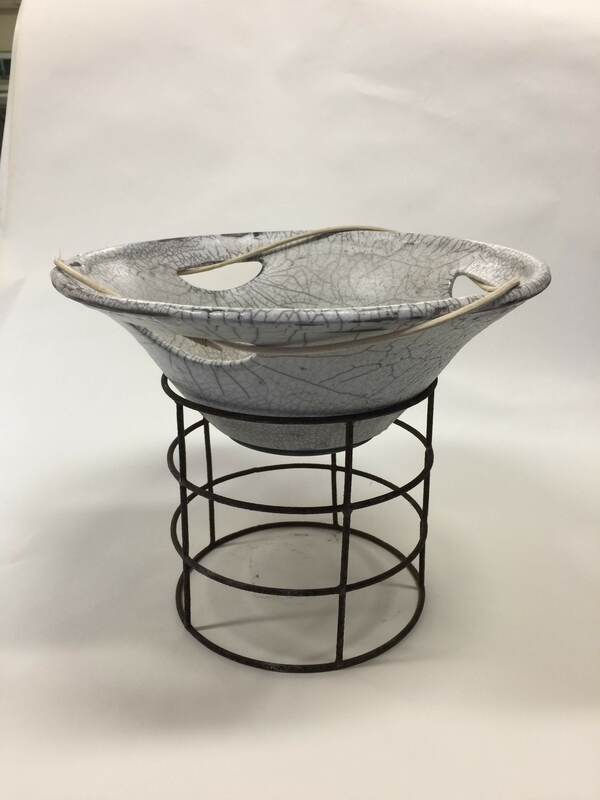 white raku fired bowl mounted on iron ring stand