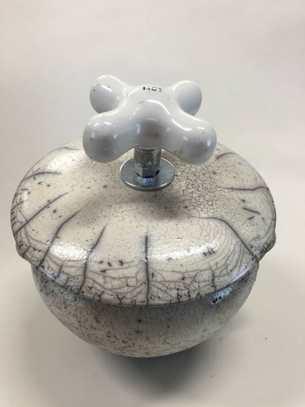 white raku pot with hot water faucet handle